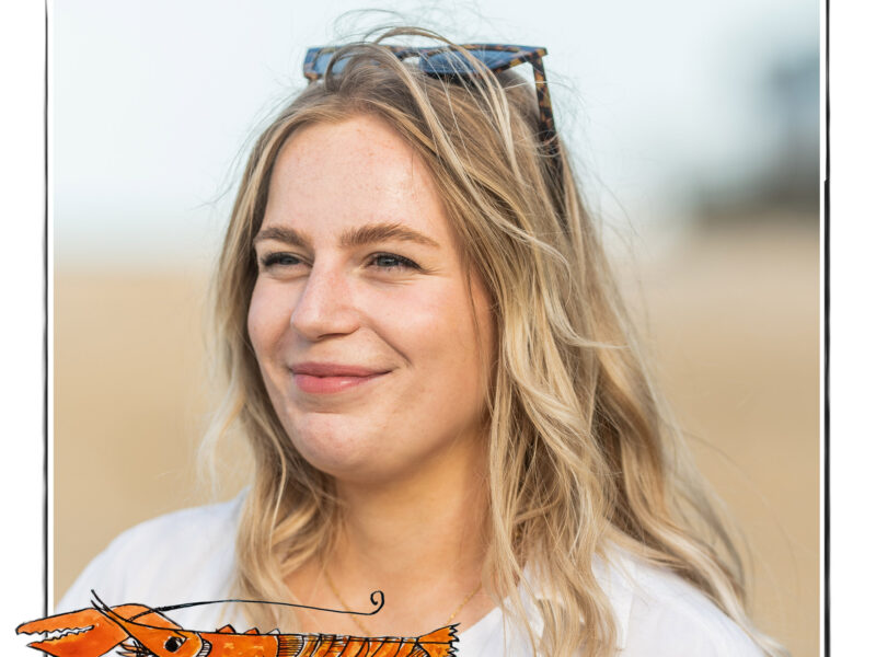 Image of a smiling woman against the background of a beach. It is framed by a sketch line and overlaid with a hand drawn image of a lobster