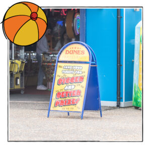 Image of the sign outside an amusement arcade in Norfolk, UK, framed with a sketch line and overlaid with a hand drawn image of a beach ball