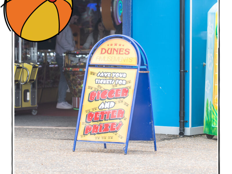 Image of the sign outside an amusement arcade in Norfolk, UK, framed with a sketch line and overlaid with a hand drawn image of a beach ball